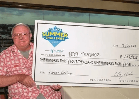 Robert Traynor holding his Del Mar Summer Challenge winner's check